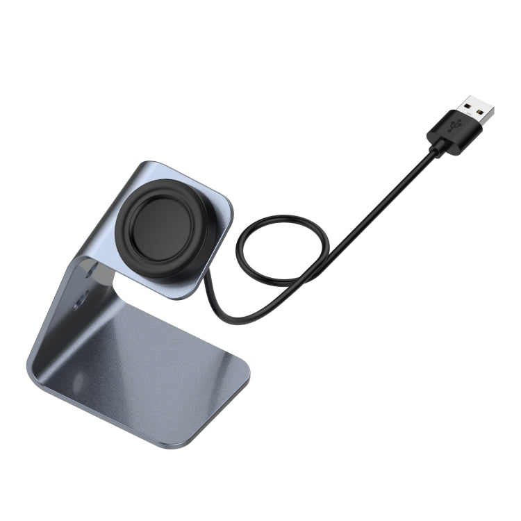 Grey aluminum magnetic watch charger stand with USB-A cable, angled charging dock