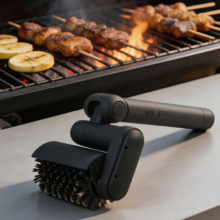 Black electric BBQ rack cleaning brush with two bristle heads on countertop