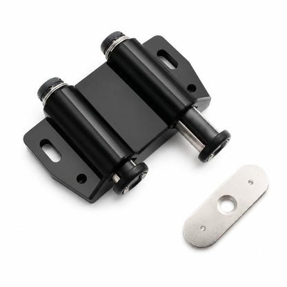 Black handle-free cabinet door latch with metal mounting plate and striker pad