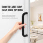 Black cabinet pull handle with curved U-shaped grip, held by a hand.