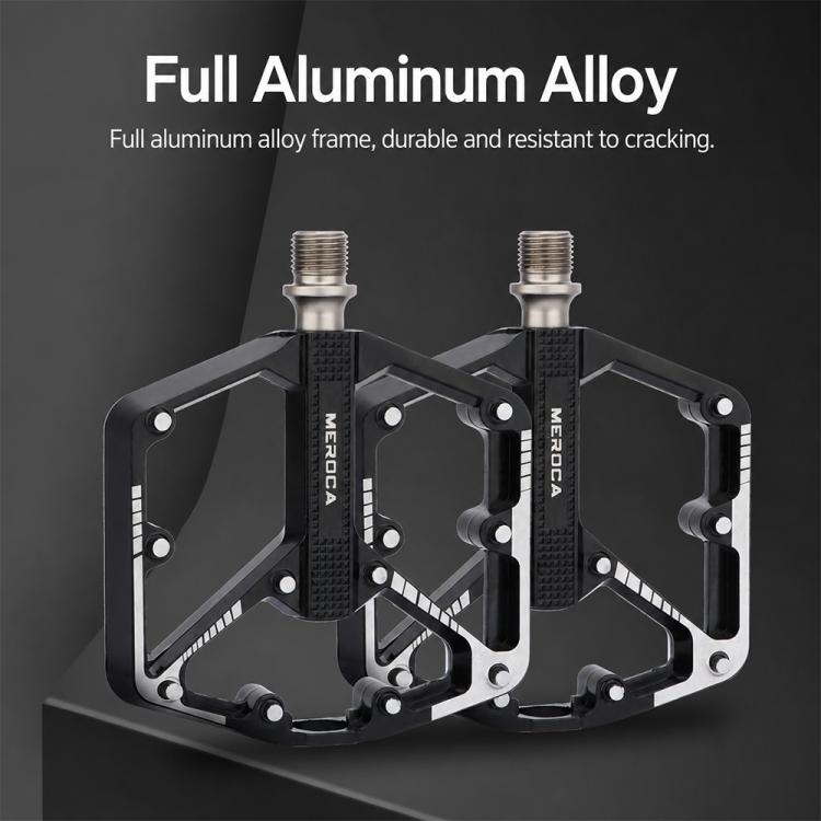 Black aluminum mountain bike pedals with textured grip and anti-slip pins