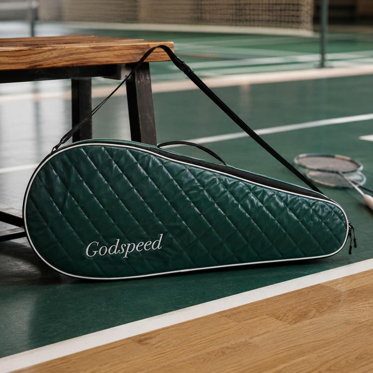 Dark green quilted badminton racket bag with black trim and zippered closure