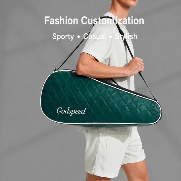Dark green quilted badminton racket bag worn on one shoulder with adjustable strap