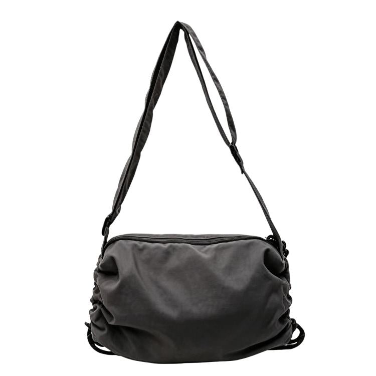 Grey nylon drawstring crossbody bag with adjustable shoulder strap and cinch closure