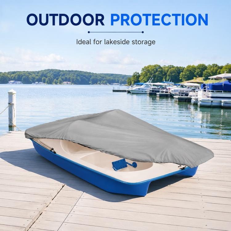Grey pedal boat cover laid over blue pedal boat on a wooden dock