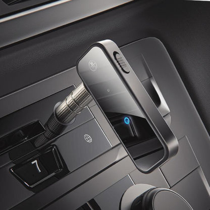 Mini wireless Bluetooth AUX audio adapter with 3.5mm plug, black body and blue light