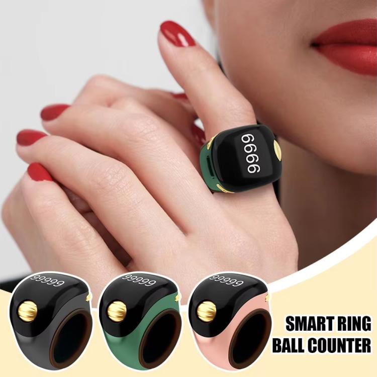 Green smart prayer ring counter worn on fingers, gold roller button visible