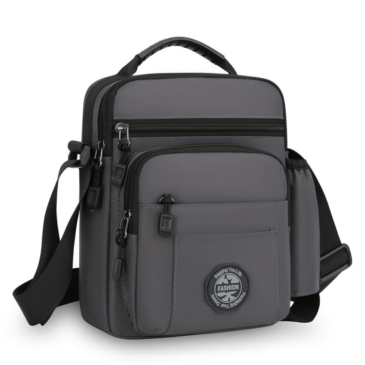 Gray men's crossbody bag with front zip pocket and top carry handle