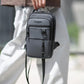 Men's dark crossbody sling bag with front zip pocket and adjustable strap on model
