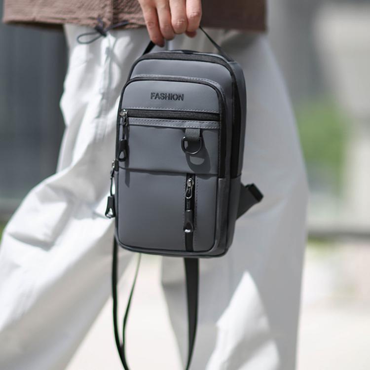 Men's dark crossbody sling bag with front zip pocket and adjustable strap on model