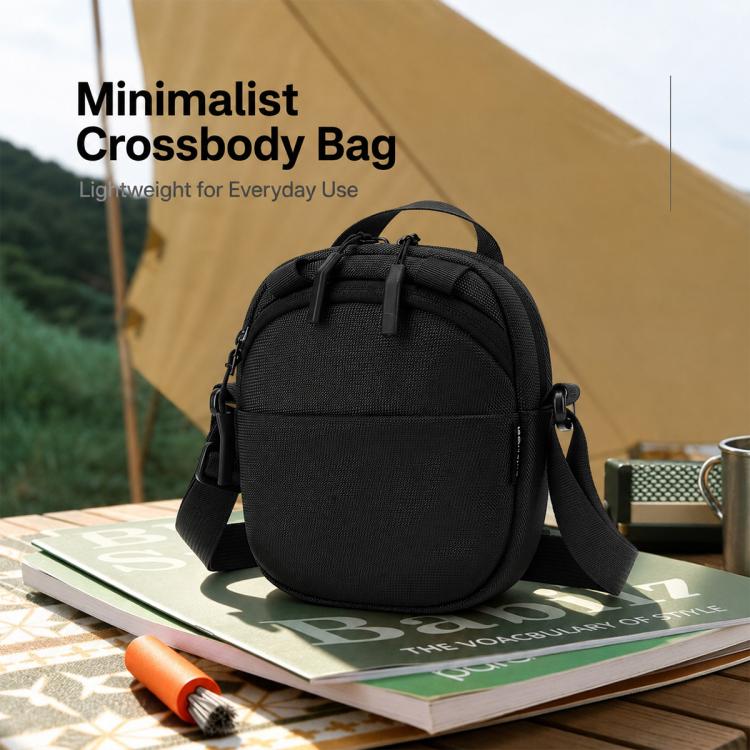 Black nylon crossbody bag with front zip pocket and adjustable shoulder strap