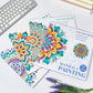 Mandala painting sets on a desk, colorful flower designs on multiple pages
