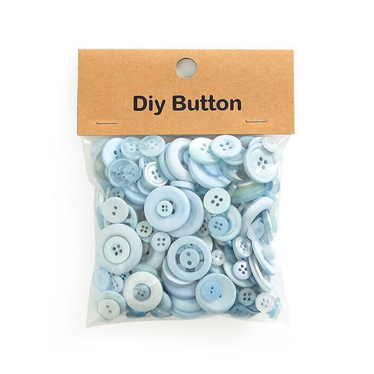 Pack of light blue round resin craft buttons in a clear plastic bag