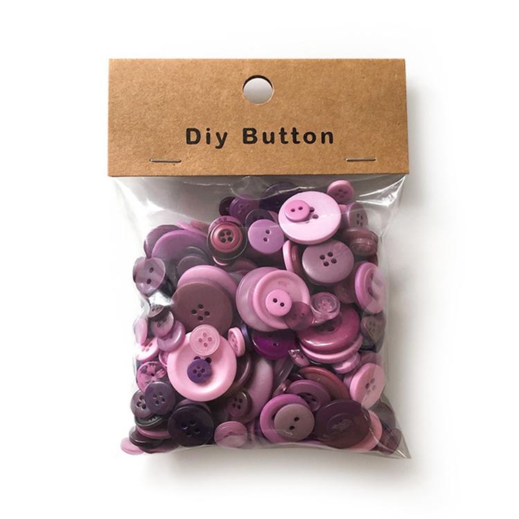 Pack of purple and pink round resin craft buttons in a clear plastic bag