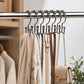 Mountain-shaped metal curtain hooks on rod with mixed metal finishes