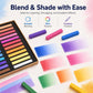 Pastel chalk sticks with color swatch blocks on paper, including purple, pink, and blue.