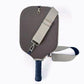 Dark gray perforated neoprene paddle bag with light gray adjustable shoulder strap.