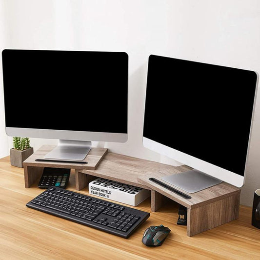 Light wood rotating monitor stand with storage shelves for keyboard and mouse.