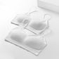 Three white camisole-style disposable undergarments, folded with thin shoulder straps