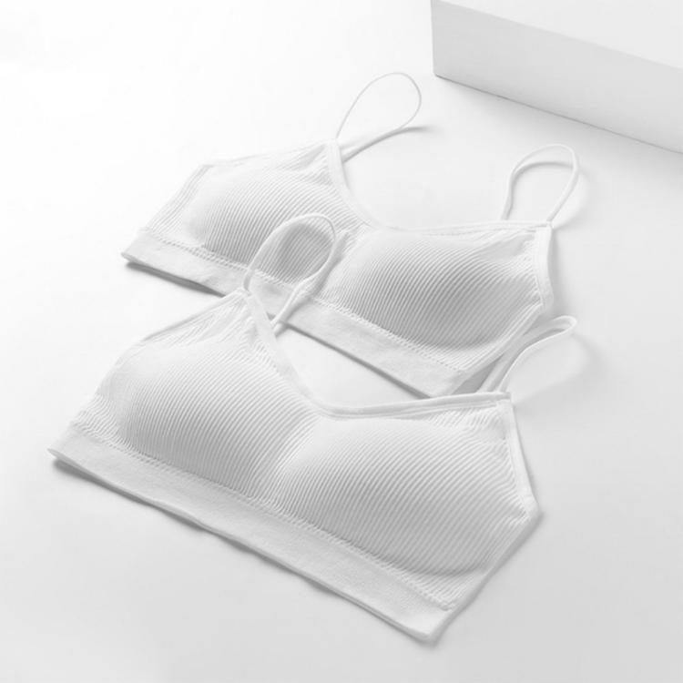 Three white camisole-style disposable undergarments, folded with thin shoulder straps