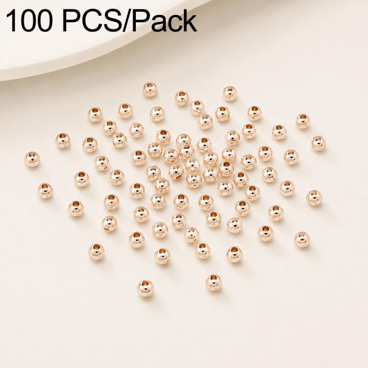 Gold-plated round spacer beads with straight holes, smooth surface; scattered pack.