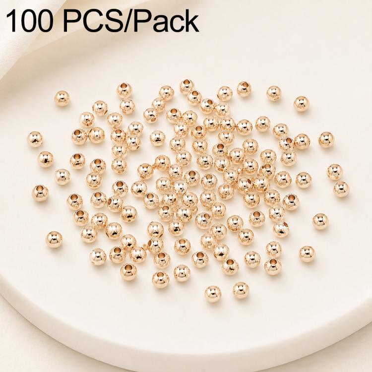 Gold-plated round spacer beads, smooth and round with visible straight holes, assorted sizes.