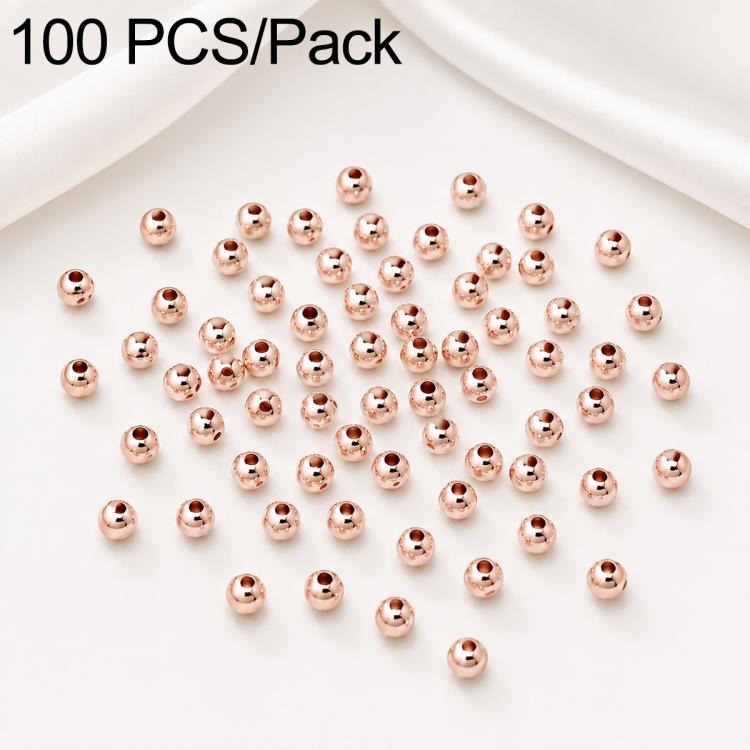 Rose-gold round spacer beads scattered, smooth finish, straight through-holes, 100-pack