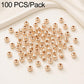 Gold-plated round spacer beads, smooth and round with straight holes; clustered arrangement.