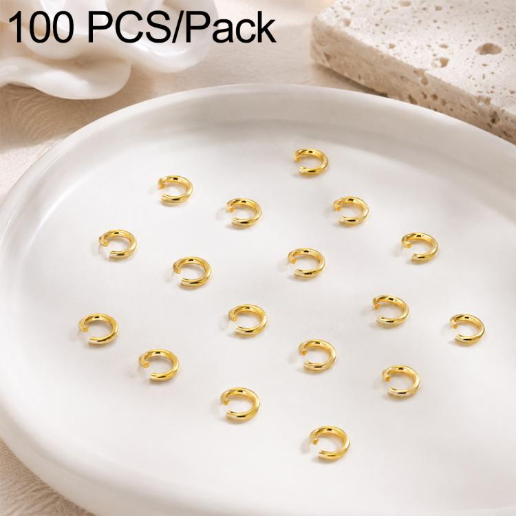 Gold open jump rings, small split loops displayed in a round dish