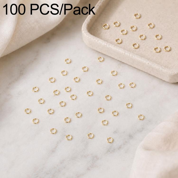 Gold open jump rings, 100-piece set with rings scattered around a stone tray