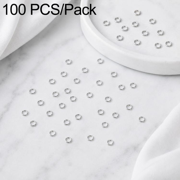 Silver open jump rings, 100-piece set with rings in a white dish and scattered