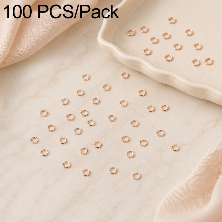 Rose gold open jump rings, 100-piece set scattered around a tray dish for DIY