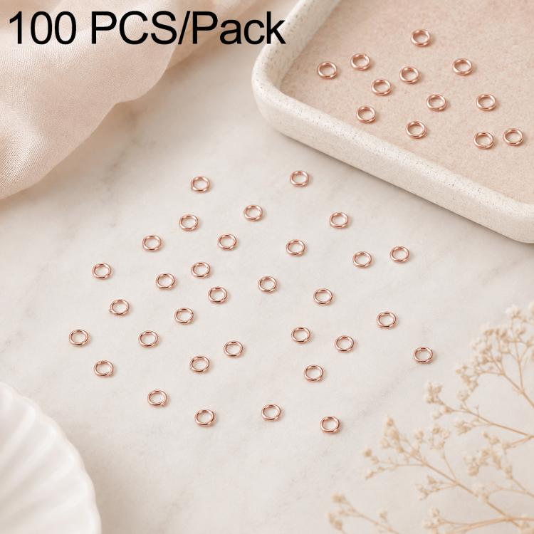 Rose gold open jump rings, 100-piece set with rings piled in a tray and scattered