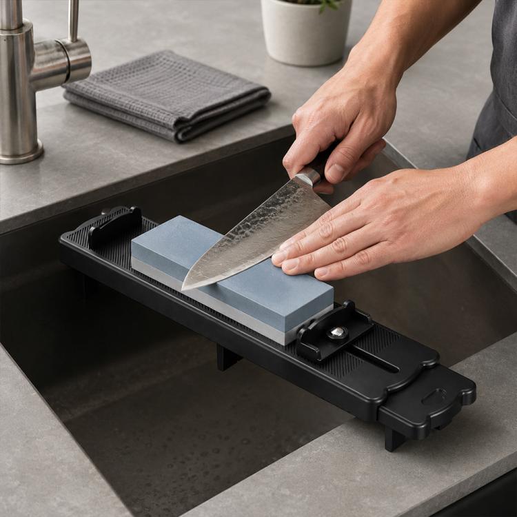 Black anti-slip whetstone holder bridge across a kitchen sink with sharpening stone
