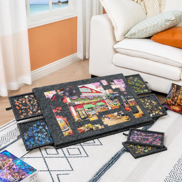 Grey felt puzzle board with colorful picture tiles and 6 drawer panels on living room floor