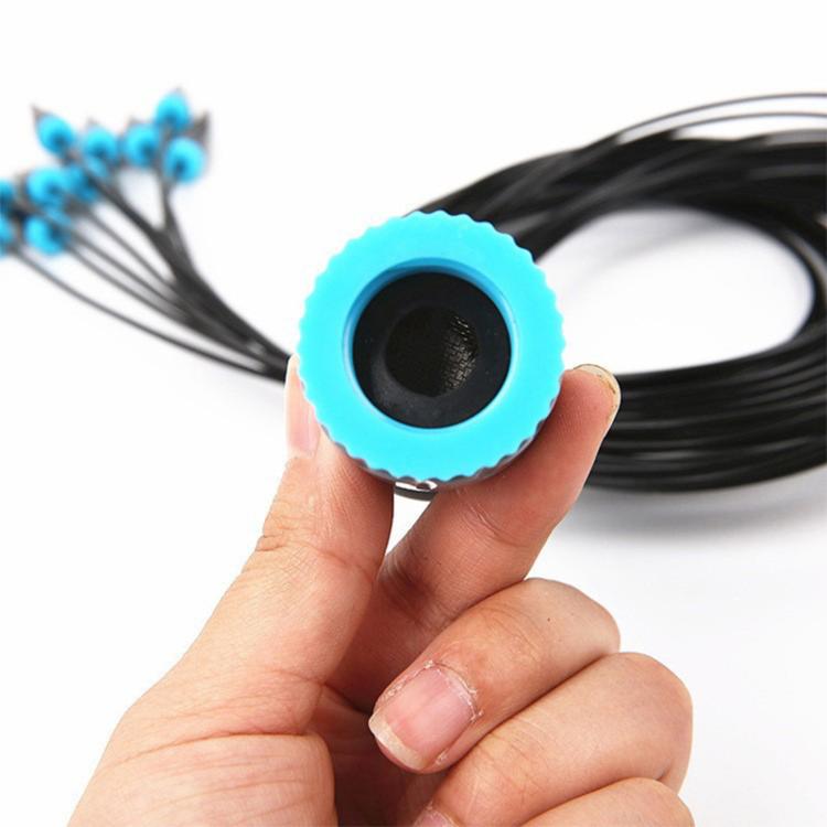 Blue drip hose tip connector with black tubing and stakes on drip irrigation kit