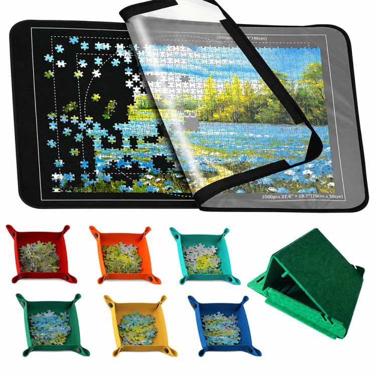 Foldable black puzzle mat with blue landscape print, open with carry strap and colorful sorting trays
