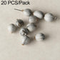 White and gray round seed beads with drilled holes, strung on a wire pin