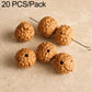 Warm caramel-brown round seed beads with carved texture and drilled holes on a pin