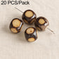 Dark brown seed beads with tan circular centers and through holes on pins.