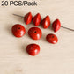 Polished red teardrop beads with small holes on metal pin.