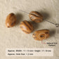 Natural amber patterned seed beads with small holes, including striped and eye-like shapes