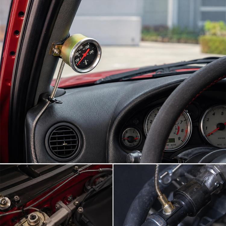 Mechanical water temperature gauge for car dashboard, round black face with red needle.