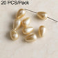 Beige gold teardrop faux pearl beads with textured finish on metal pins
