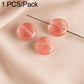 Round pink coral-like stone beads on wire pin with striped texture