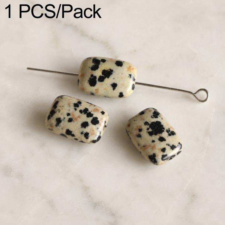 Oval white stone beads with black speckles on wire pin, smooth polished surface