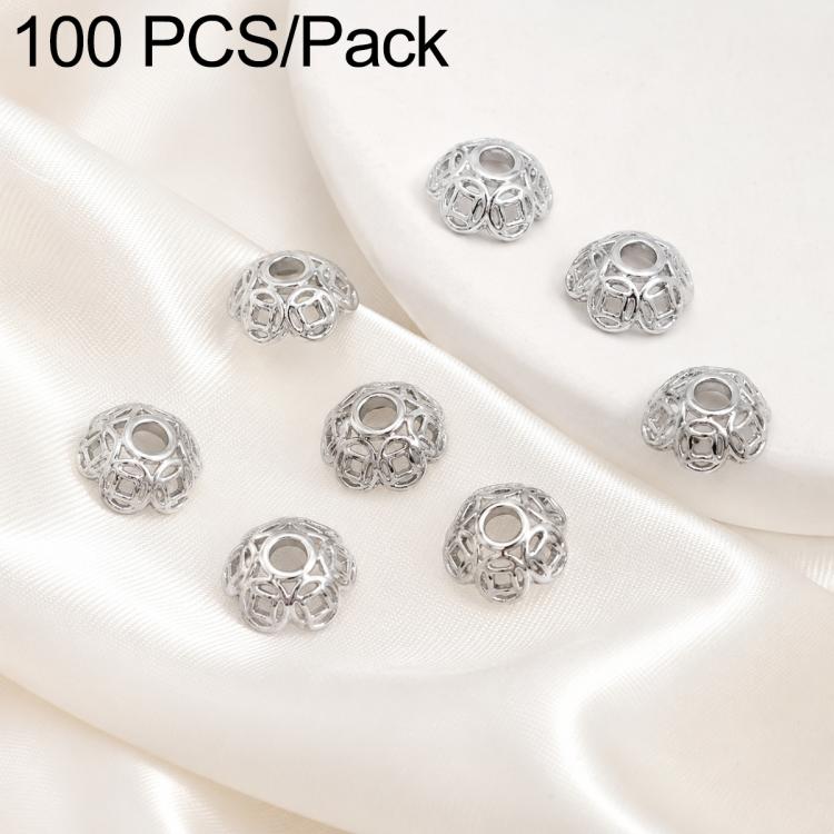 Silver hollow flower bead caps, angled view showing raised petal-like openwork pattern