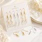 DIY earring hook display card with mixed gold, silver, and clear charm earring parts