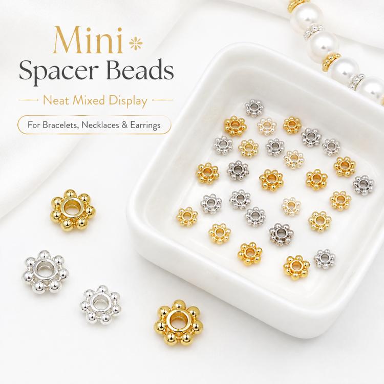 Small mixed gold and silver snowflake bead cap spacers in square tray, assorted set