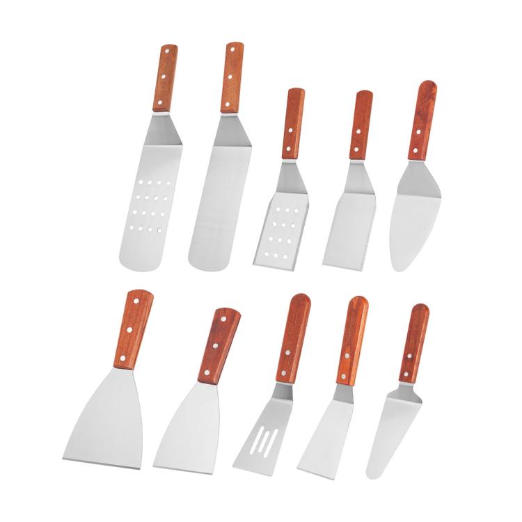 Set of stainless steel cooking spatulas with wooden handles, including slotted and triangular blades
